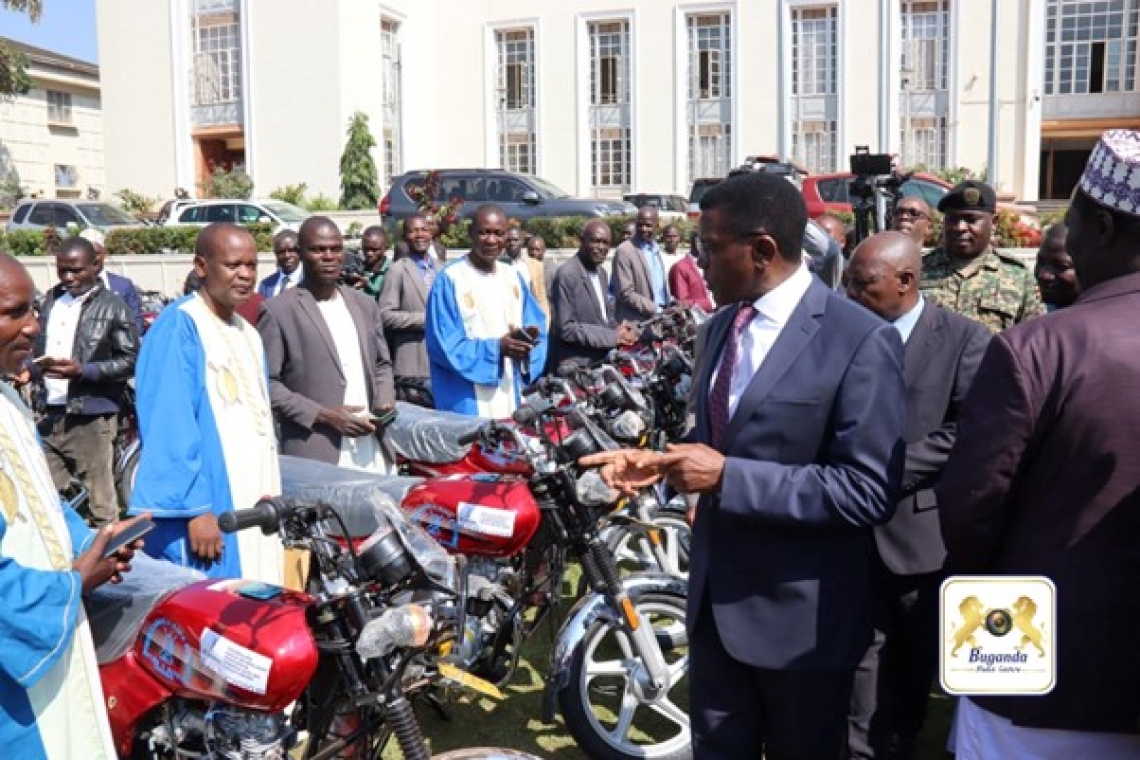 The Katikkiro handing over the motorcycles to the sub County chiefs Image